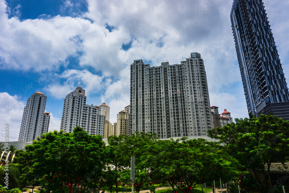 High rise building like a skycraper surrounding with green trees and beautiful clear sky as background photo taken in Jakarta Indonesia