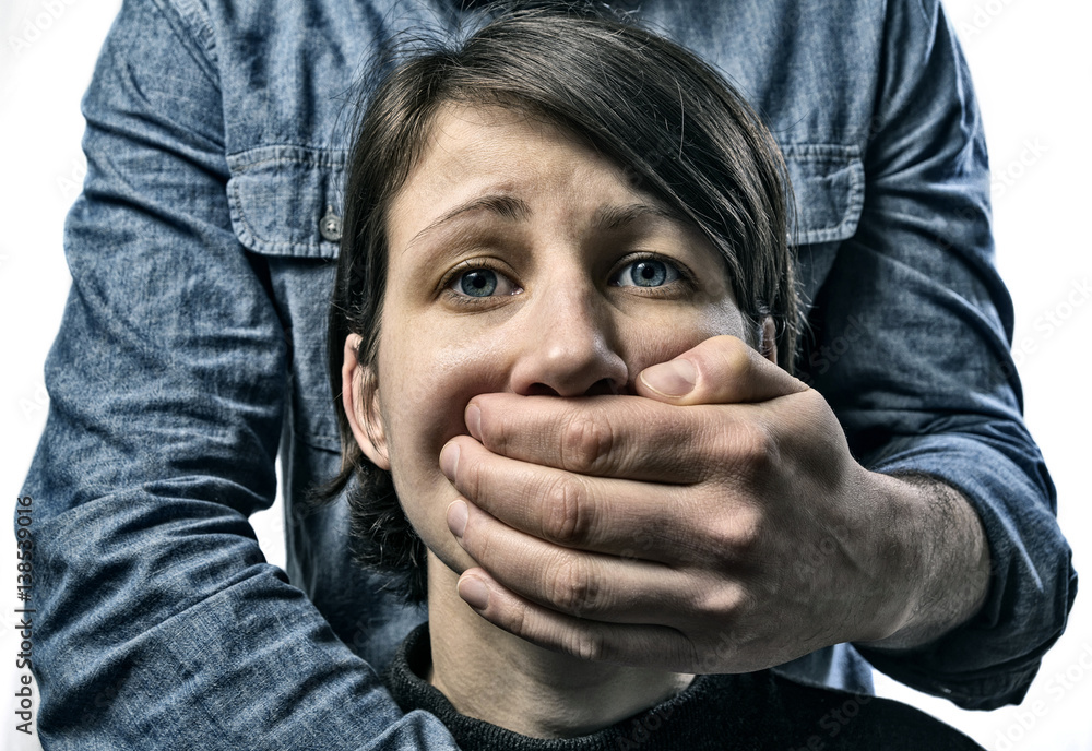 Man covers woman's mouth. Concept of domestic violence, slavery