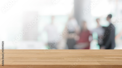 Wood table top and blurred bokeh business work space interior background - can used for display or montage your products.