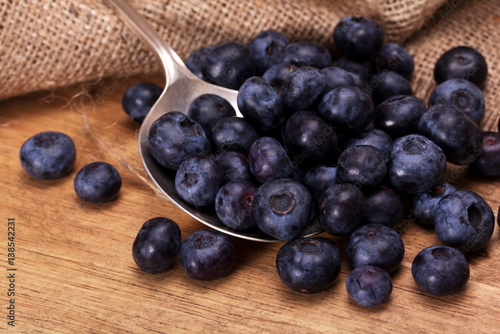 Blueberries and spoon on a rustic background Blueberries and spoon on a rustic background