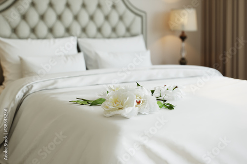 3d illustration of white peony on a bed in beige badroom 