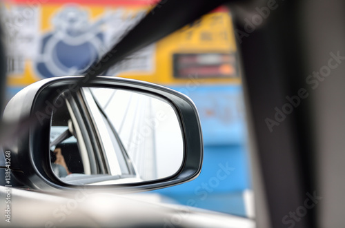 Rear view mirror reflecting car © suman
