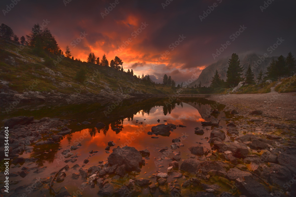 View on lovely mountain lake at fiery sunset