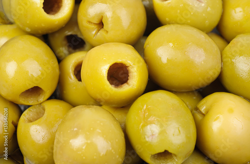 Marinated green olives as food background