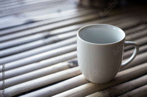 White cup on a wooden background