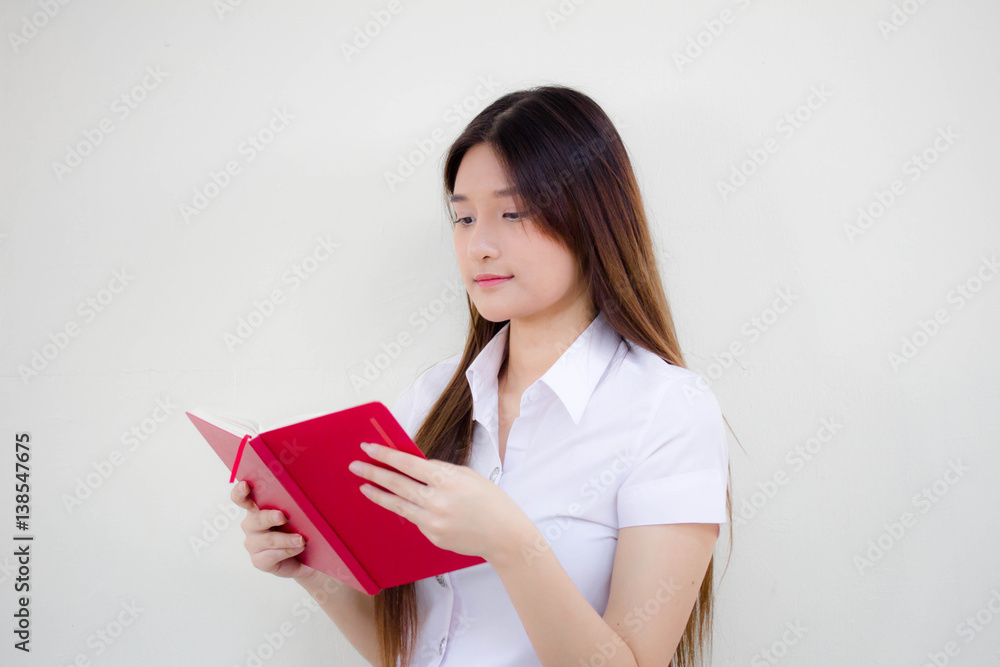 Portrait of thai adult student university uniform beautiful girl reading red book Portrait of thai adult student university uniform beautiful girl reading red book