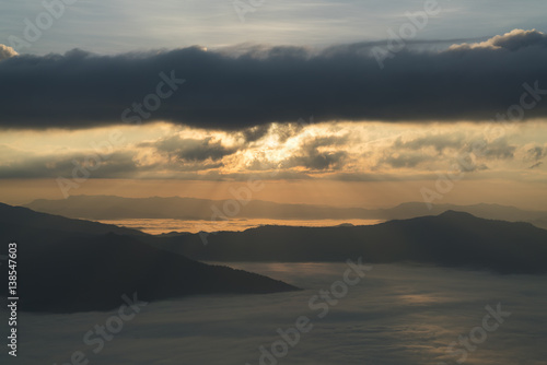 Sunrise with shine and fog on mountain landscape in the morning.