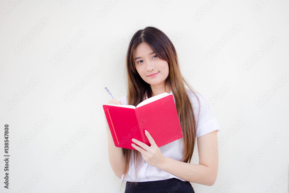 Portrait of thai adult student university uniform beautiful girl reading red book Portrait of thai adult student university uniform beautiful girl reading red book