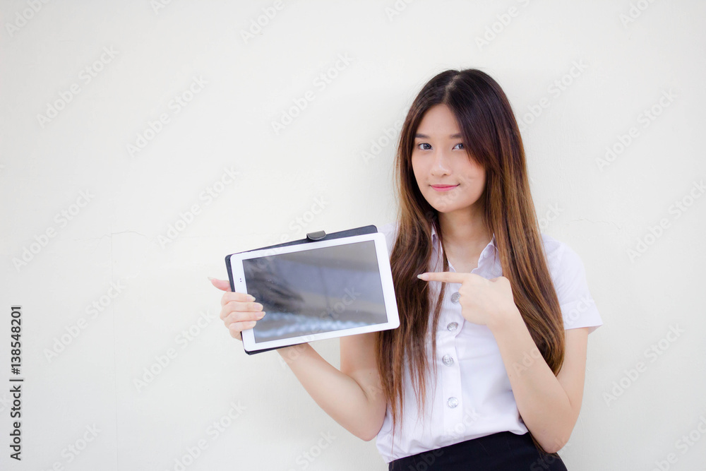 Portrait of thai adult student university uniform beautiful girl using her tablet. Portrait of thai adult student university uniform beautiful girl using her tablet.