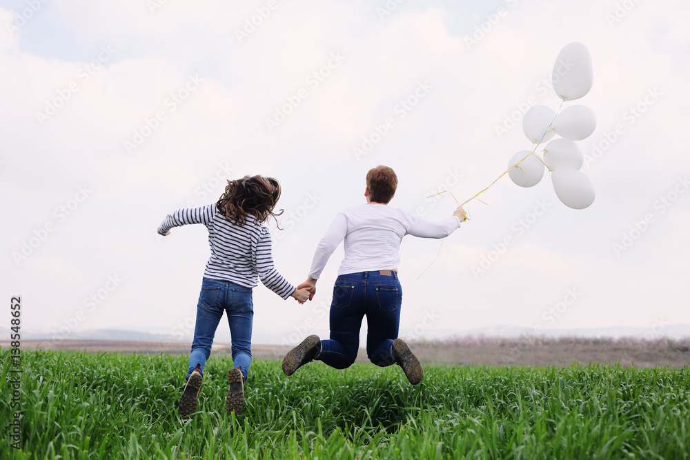 Happy mother and daughter jumping together. Mother day. Happy mother and daughter jumping together. Mother day.