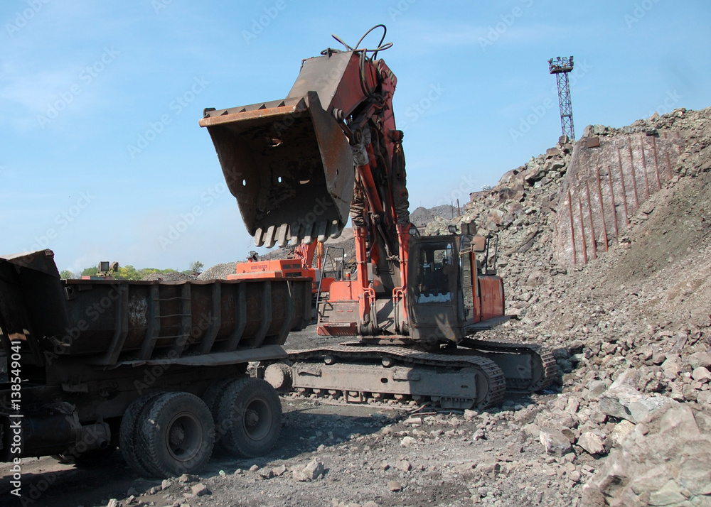 Industrial equipment excavator in quarry load stones 