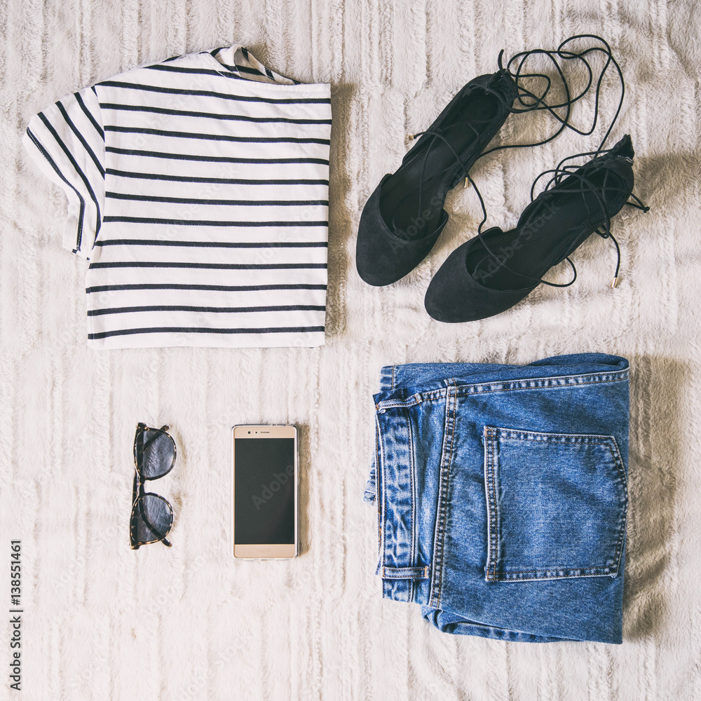 perfect spring outfit accessories. flat lay of a trendy woman fashion outfit. denim jeans, striped shirt, lace up flats, sunglasses and a elegant smartphone. top view.
perfect spring outfit accessories. flat lay of a trendy woman fashion outfit. denim jeans, striped shirt, lace up flats, sunglasses and a elegant smartphone. top view.