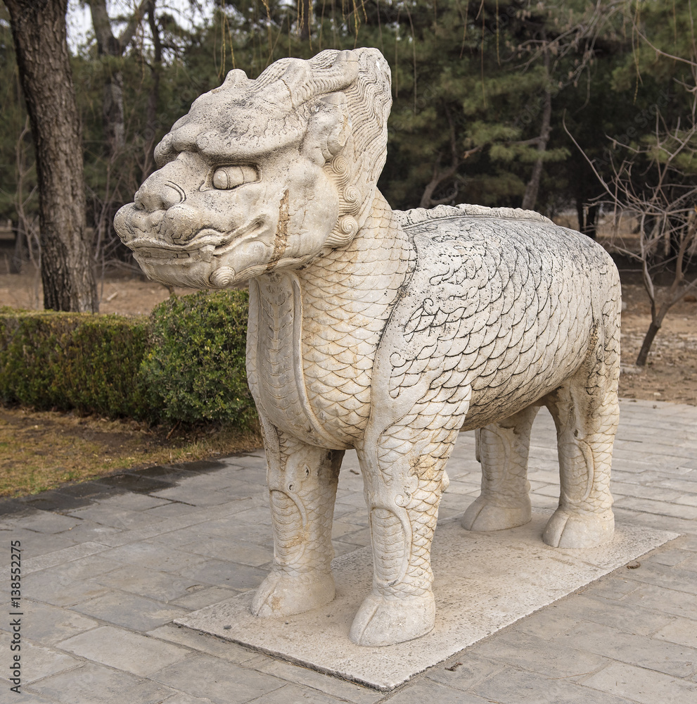 Single statue of mystical creature half lion half dragon made of stone in an alley to Ming dynasty emperor's tomb Single statue of mystical creature half lion half dragon made of stone in an alley to Ming dynasty emperor's tomb