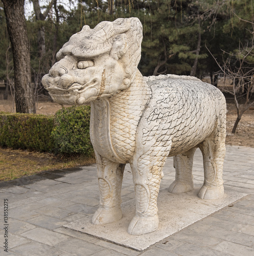 Single statue of mystical creature half lion half dragon made of stone in an alley to Ming dynasty emperor's tomb