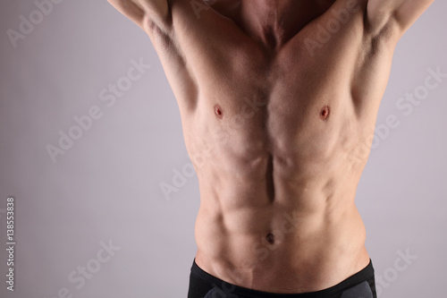 Close up of muscular male torso, chest and armpit hair removal. Male Waxing