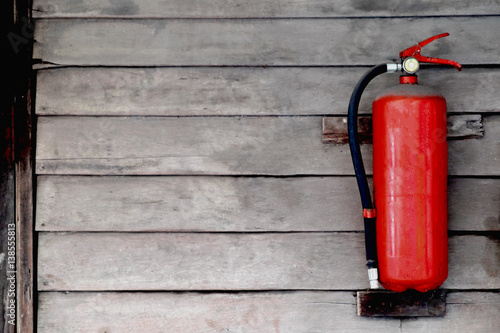 Fire extinguisher on wooden wall