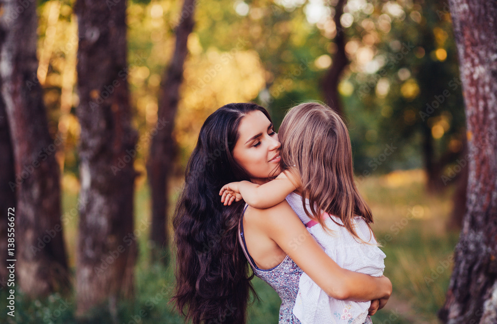 Mother holding a child outdoor. Happy family concept. Baby girl and mom. Mother's Day Mother holding a child outdoor. Happy family concept. Baby girl and mom. Mother's Day