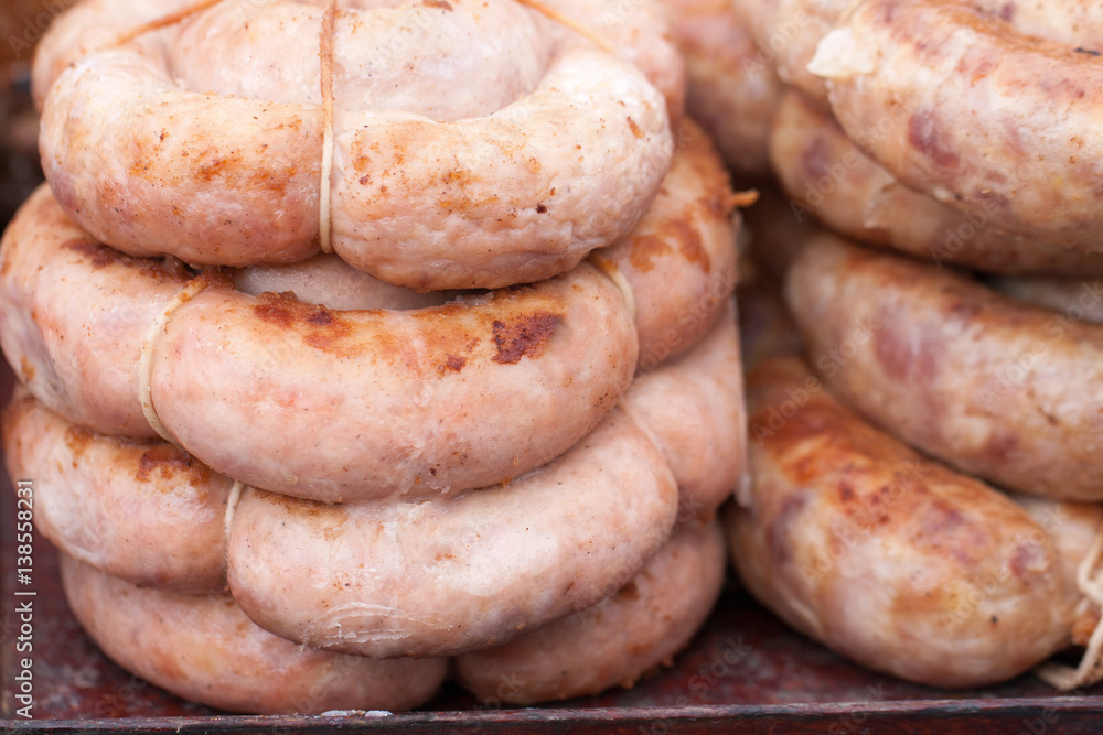 Roasted spiral pork sausages as a background. Selective focus Roasted spiral pork sausages as a background. Selective focus