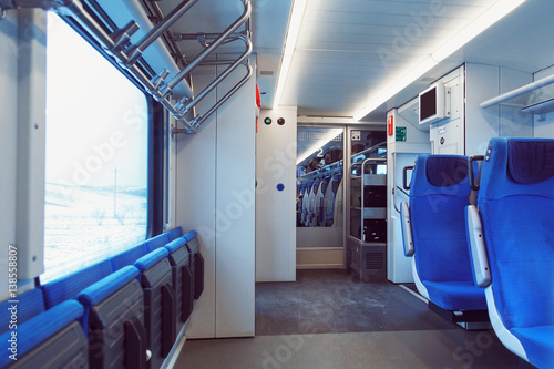 The interior of carriage with seats for passengers and their bicycles in high-speed commuter train.