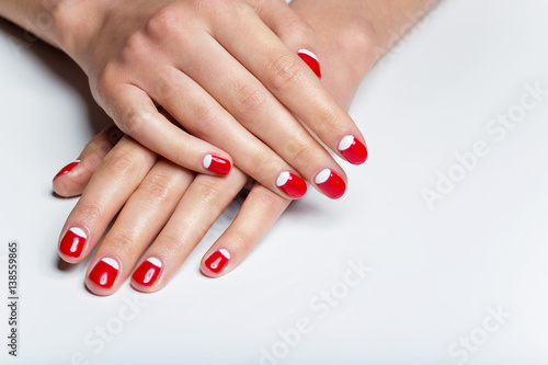 Female hands with red and white nails