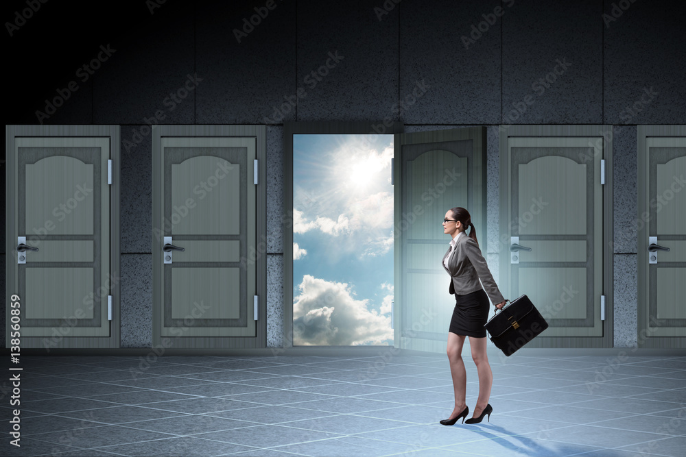 Businesswoman walking towards open door Businesswoman walking towards open door