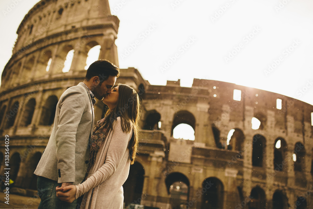 Loving couple in front of the Colosseum in Rome