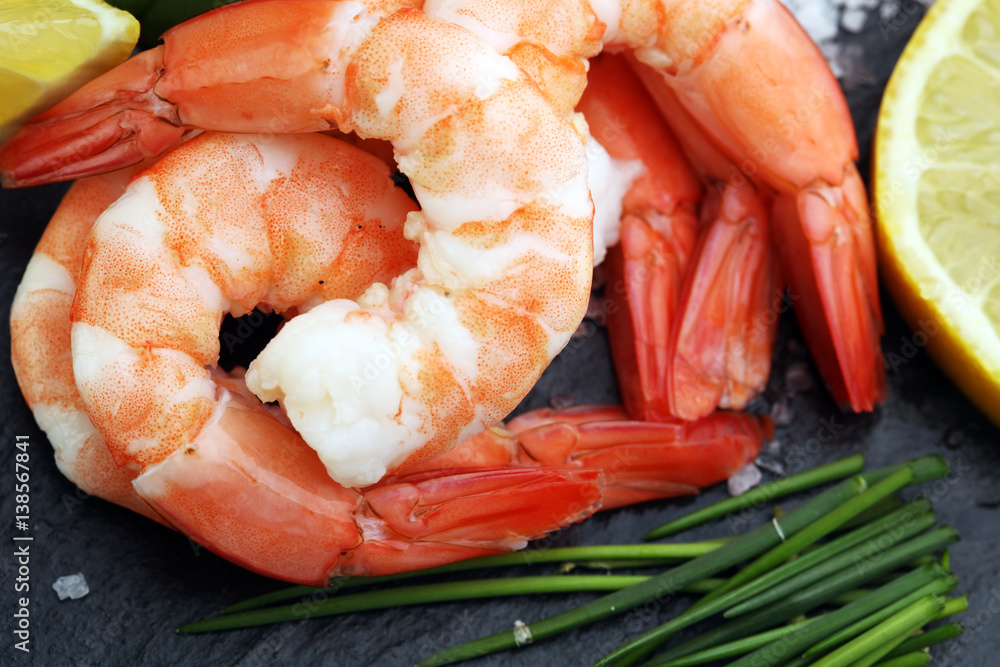 Delicious sauteed shrimp heart with cajun seasoning and lime on dark stone Delicious sauteed shrimp heart with cajun seasoning and lime on dark stone