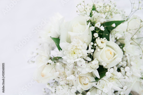 White roses wedding bouquet lying down. Isolated on white. © Sergey
