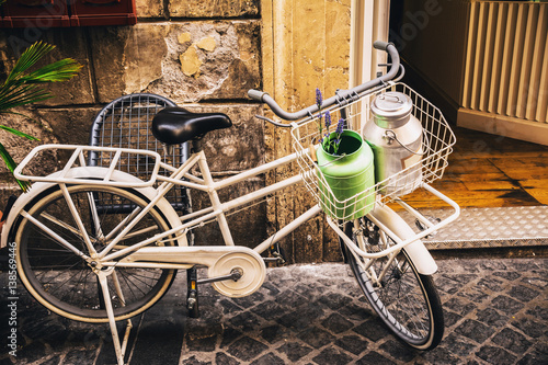 White bicycle standing on the street photo