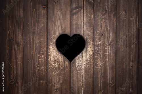 Old rusty wooden planks with love heart sign