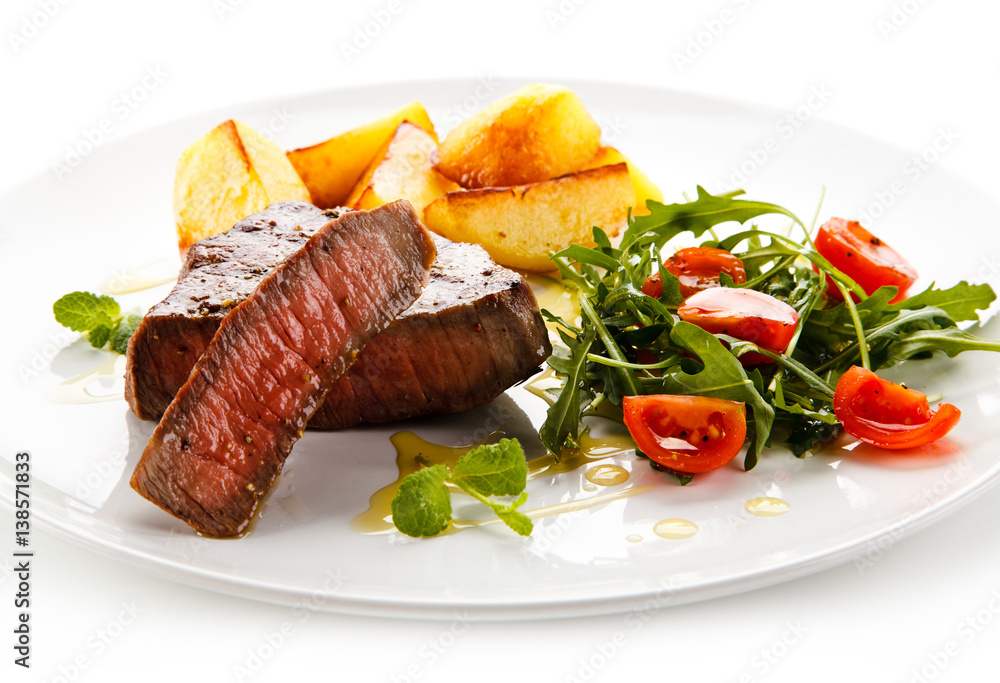Grilled steaks, baked potatoes and vegetables Grilled steaks, baked potatoes and vegetables