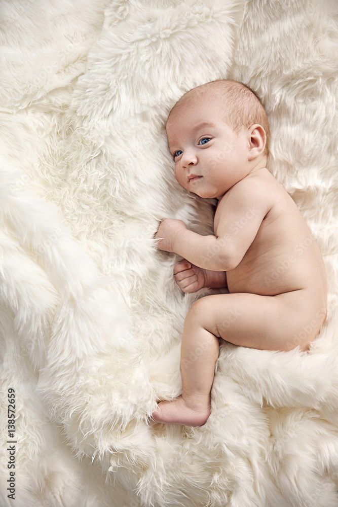 Calm newborn child laying on the soft blanket Calm newborn child laying on the soft blanket