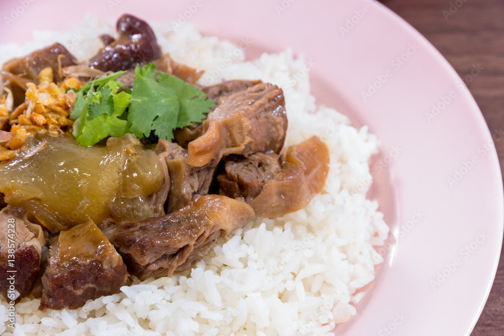 Thailand style rice braised pork and soup on wooded backgound Thailand style rice braised pork and soup on wooded backgound