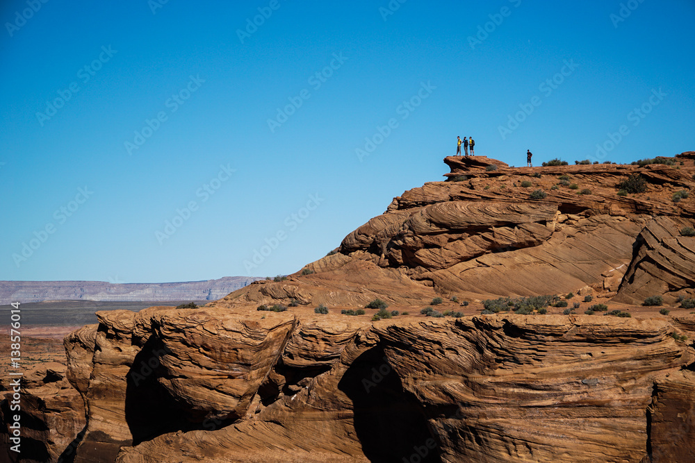Group of people on top of a mountain on Horseshoe Bent