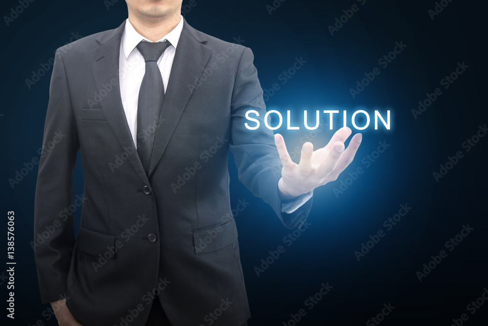 Professional businessman in blue tone background hold SOLUTION on hand in business concept Professional businessman in blue tone background hold SOLUTION on hand in business concept