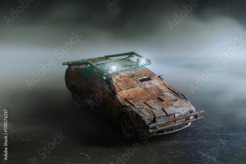 Obraz na płótnie Post - apocalyptic handmade toy car on black background with smoke w salonie