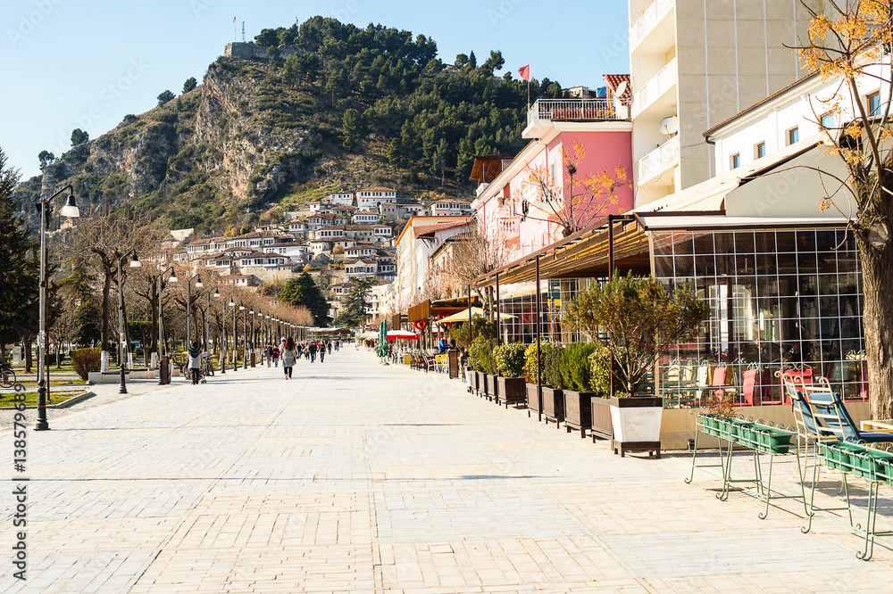 Obraz premium View to Berat, historic city in the south of Albania, situated on a hill with white houses built one over another. Captured from the pedestrian street on a sunny spring day.