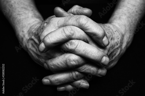 Old hands clasped together. Black and white photography