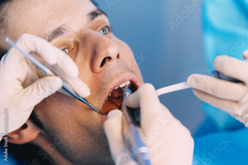 Dentists with a patient during a dental intervention.