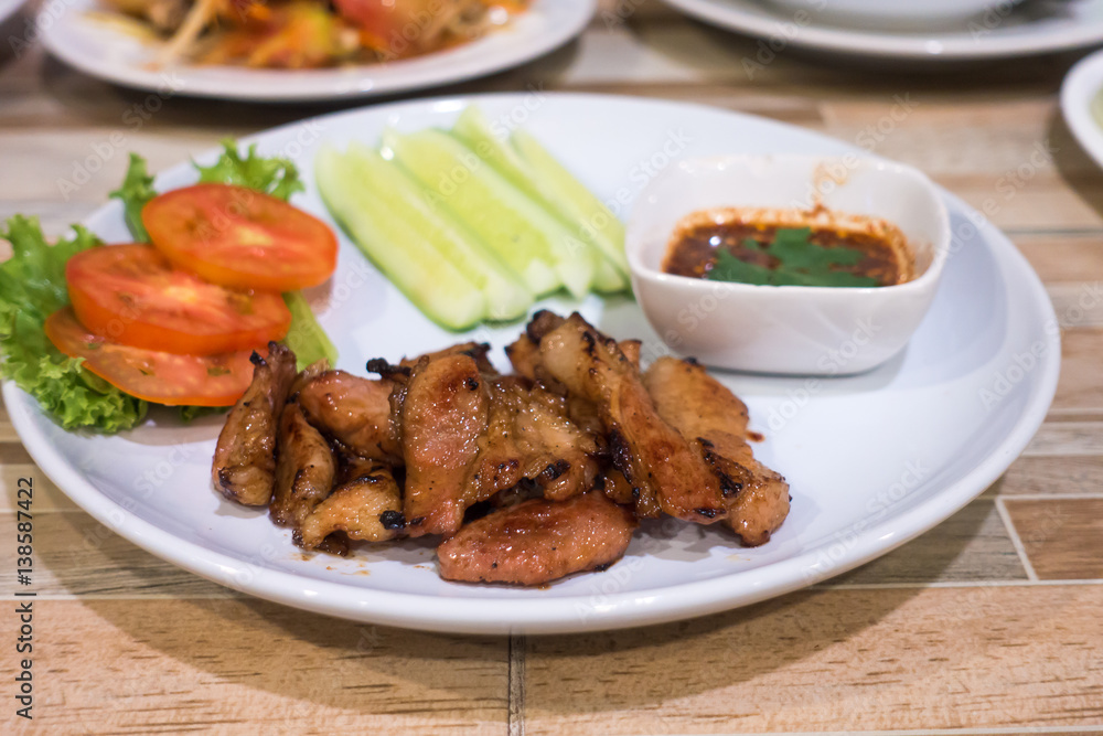 Grilled pork and sauce with salad vegetable .Thai traditional food.selective focus Grilled pork and sauce with salad vegetable .Thai traditional food.selective focus