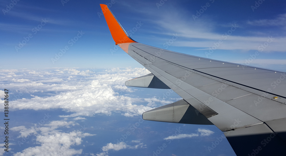 Wing airplane over the blue sky while flying