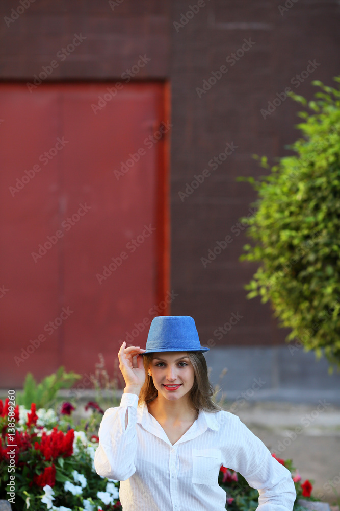 Beautiful woman holding hat