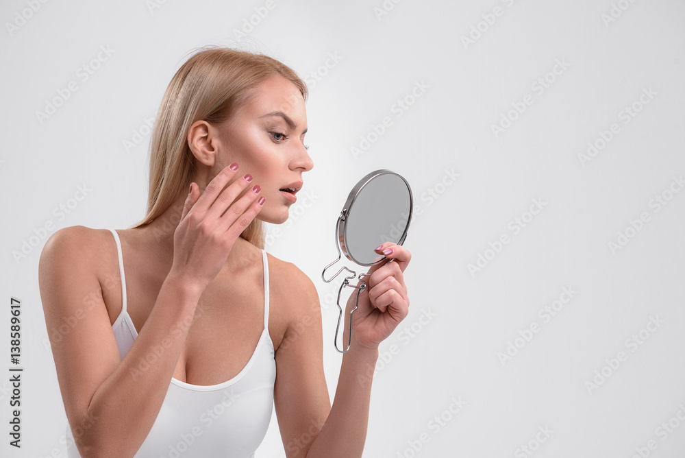 Young woman is caring of her skin Young woman is caring of her skin