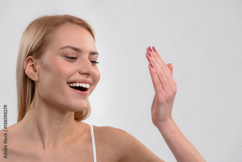 Young woman is satisfied with skincare treatment Young woman is satisfied with skincare treatment