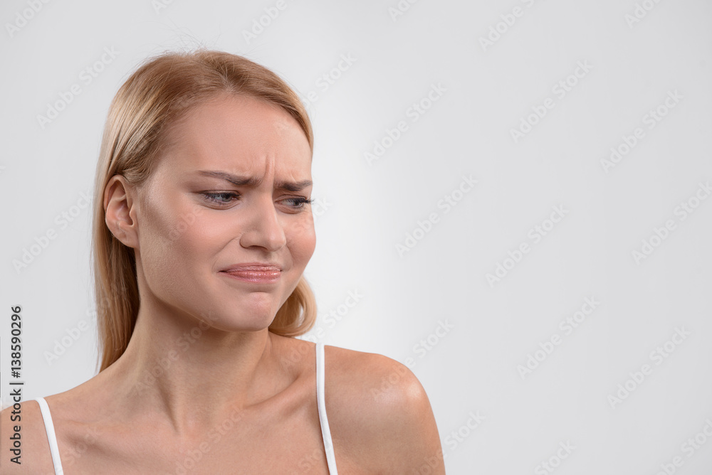 Blond girl showing her aversion about something Blond girl showing her aversion about something
