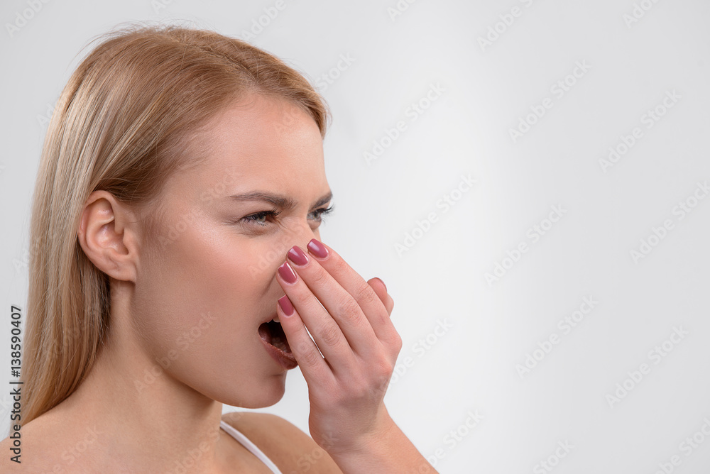 Young woman does not like her breath Young woman does not like her breath