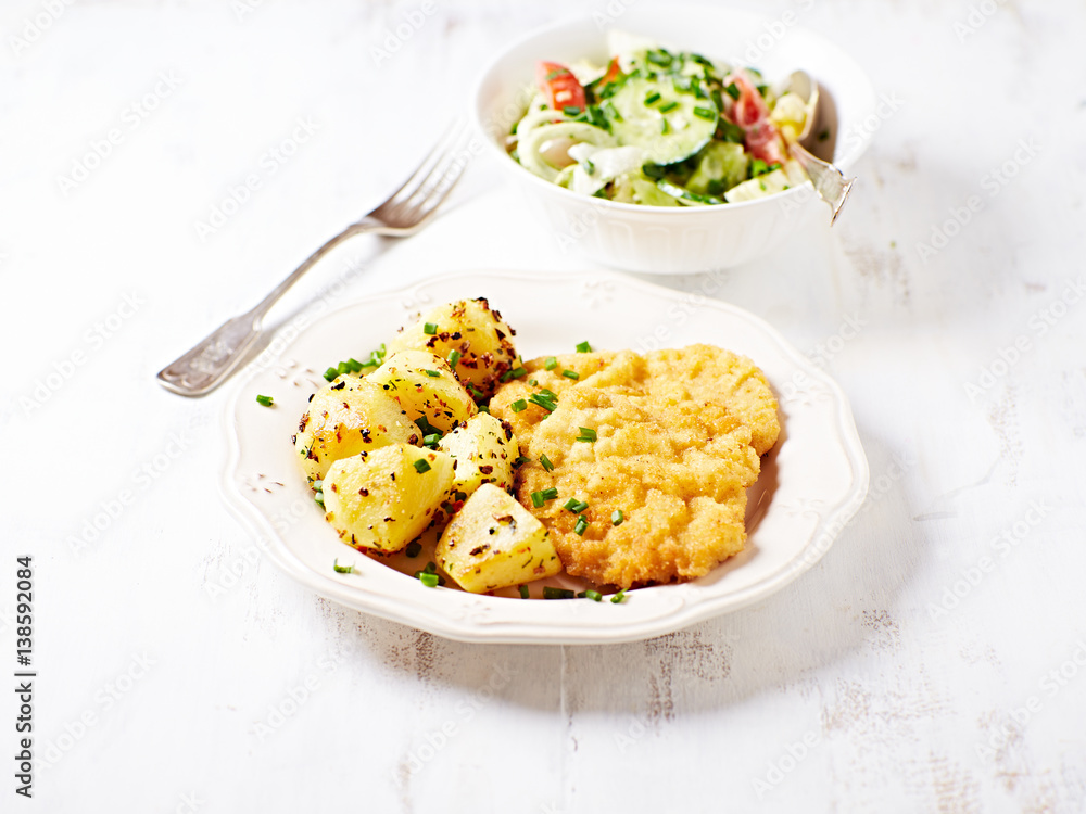 Breaded pork cutlet with baked potatoes; Polish cuisine Breaded pork cutlet with baked potatoes; Polish cuisine
