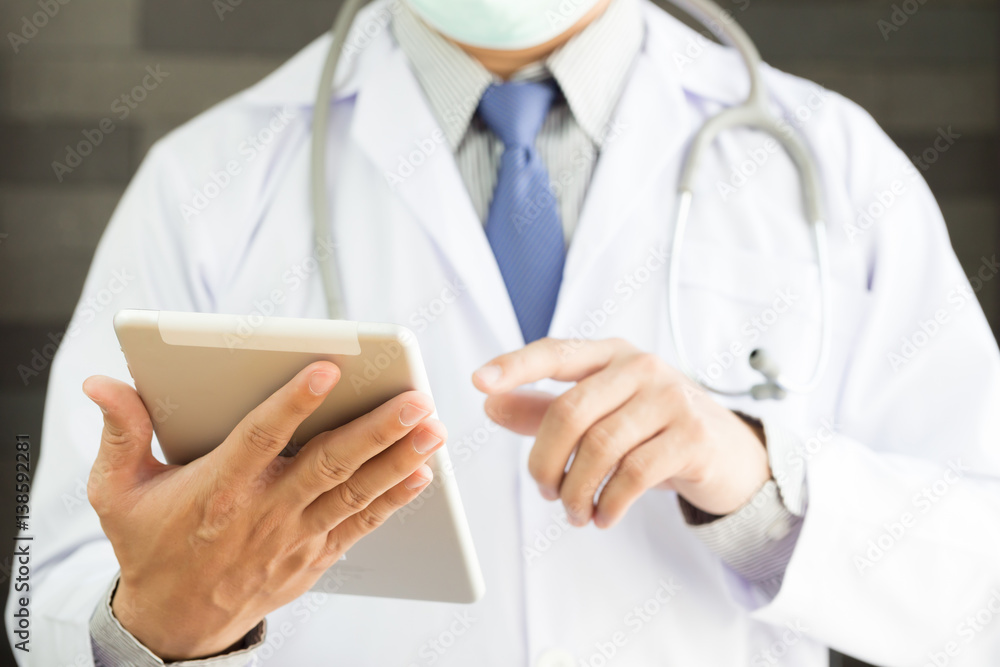 Male doctor hands holding tablet pc