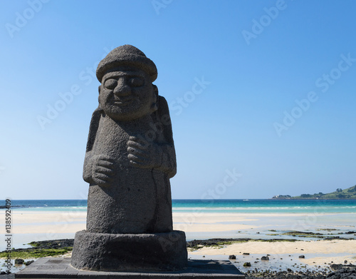 Dol hareubang statue on the beach at Jeju island symbol of Jeju do