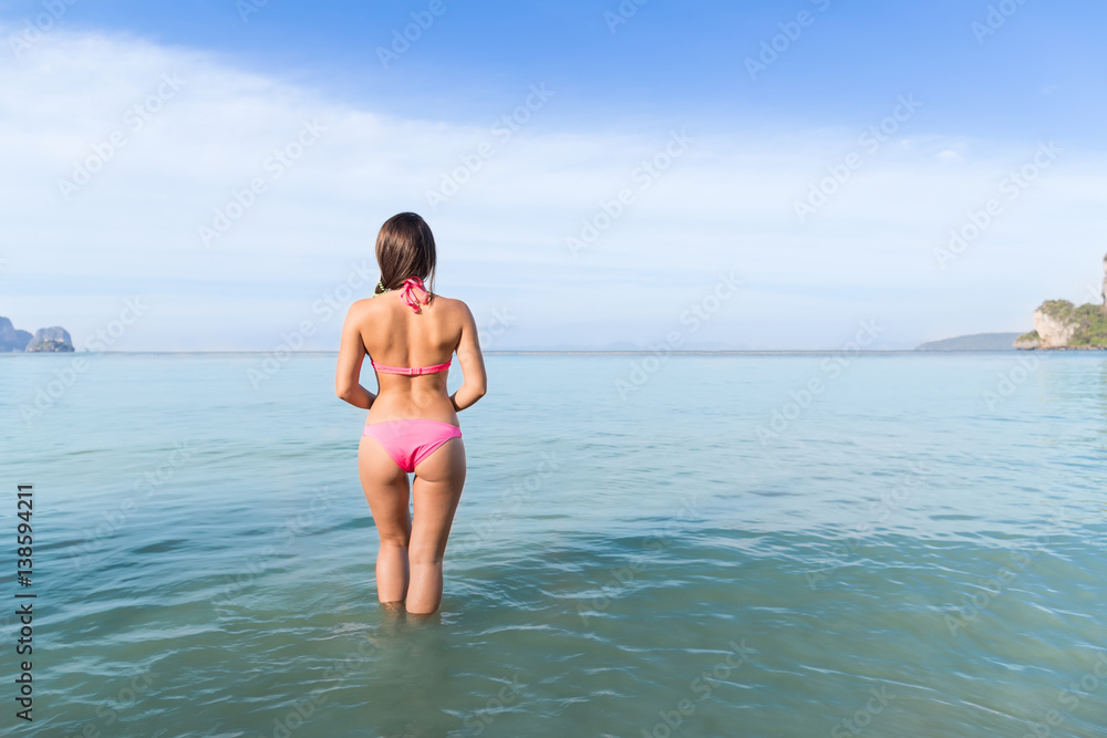 Attractive Young Caucasian Woman In Swimsuit On Beach Back Rear View, Girl Blue Sea Water Holiday Summer Vacation